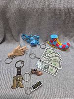 All seven keychains laid out on fabric backdrop