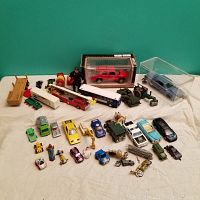 Full view of assorted toy vehicles and collectibles, showing cars, buses, motorcycles, and figures.