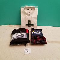 Photo showing all three items: white Bert Pulitzer dress shirt in packaging, Pierre Cardin loungewear set, and IZOD plaid pajama pants