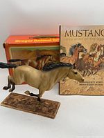 Model horse, book and box front
