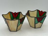 front view of both stained glass candle holders showing tulip motif
