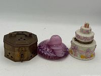 Front view of brass box, glass paperweight and cake trinket box