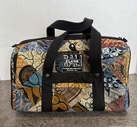 Front view showing batik patchwork design, Bali Klasik label, handles, top zipper