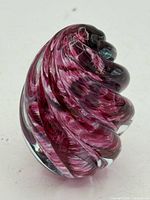 three-quarter view of purple swirl art glass paperweight