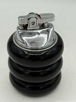 Front view of Bradlow chrome table lighter with black enamel triple-ring body