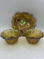 Front view of larger leaf motif bowl with two small scalloped bowls