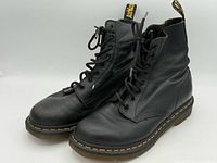 front angled view of both boots showing uppers, laces, toe wear