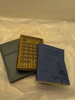 Three hardcover books stacked: Vitalized English, Tanglewood Tales, Tom Swift
