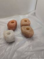 Four salt candle holders on plastic sheet