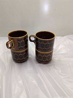 Four Hornsea Heirloom mugs stacked in two columns