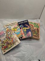 Four large children’s books laid out showing covers