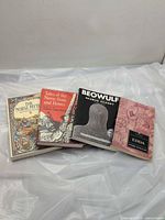 All four books front covers visible