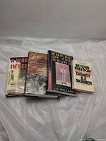Four books laid out showing covers
