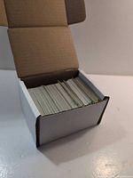 Open white card box with rows of Pokémon cards
