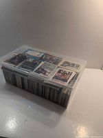 Full view of closed plastic box filled with sports cards