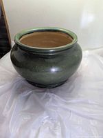 Full view of round green ceramic planter