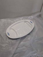Top view of white oval Corning Ware platter with cornflower motif