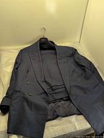 Full view of jacket and trousers laid out