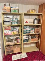 Overall view of two metal shelving units holding boxes of mason jars and pressure cooker