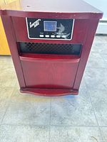 Front view showing digital control panel, heat outlet and wood cabinet