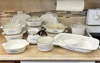 Group shot of all CorningWare Blue Cornflower pieces and glass lids