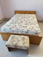 Full bed frame with mattress, box spring and bench at foot