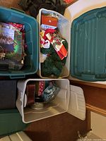 Overview of three totes showing gift bags, paper, wreath and decorations