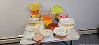 Overall lot showing glass casseroles, plastic containers, bowls and lids