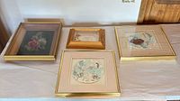 All four framed pieces laid out on table
