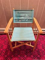 Front view of director chair showing frame and printed canvas backrest