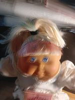 Close-up of doll’s face showing hair, eyes, vinyl condition