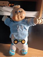 Full view of Cabbage Patch Kids boy doll standing, showing clothing and overall condition