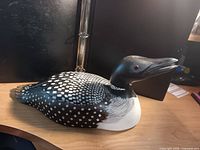 Left side view of carved wooden duck decoy