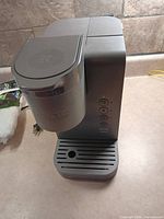 Front view of Keurig K-Slim brewer showing control panel and drip tray