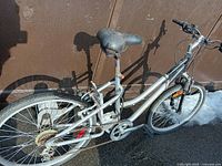 Left side view showing frame, rear wheel, drivetrain, battery pack