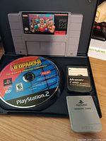 All items together: SNES cartridge, PS2 disc, two memory cards