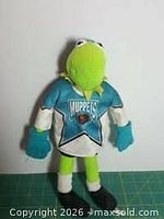Kermit the Frog plush wearing teal jersey