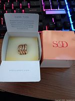Gold-tone multi-band ring in Stella & Dot box, care card visible
