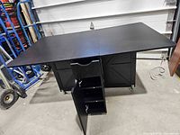 Bar cart fully opened showing extended drop-leaf top and cabinet configuration