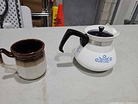 Coffee server and mug side by side on table