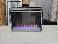 Front view of electric fireplace insert showing LED flames and crystal embers