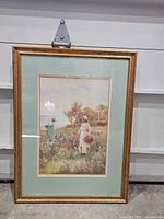 Full view of framed print with gold frame and green mat