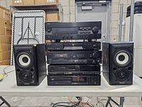 Full view of stacked AV components with speaker pair