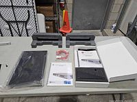 Network scanner appliance sealed in plastic with foam inserts, manuals, cables and starter kit box on table