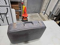 Front angled view of closed briefcase showing overall form