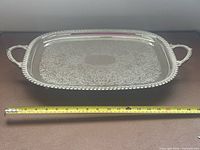 Top view of entire silver-plated platter with measuring tape for scale