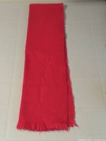 Full length view of folded red acrylic scarf