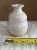 Front view of the vase with tape for scale