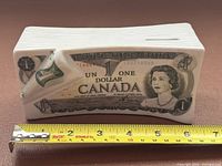 front view showing dollar bill design and measuring tape indicating length