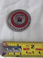 Front view showing emblem, text and size reference